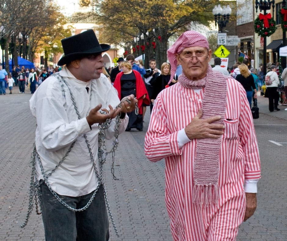 Dickens characters greeting visitors in Downtown Fayetteville